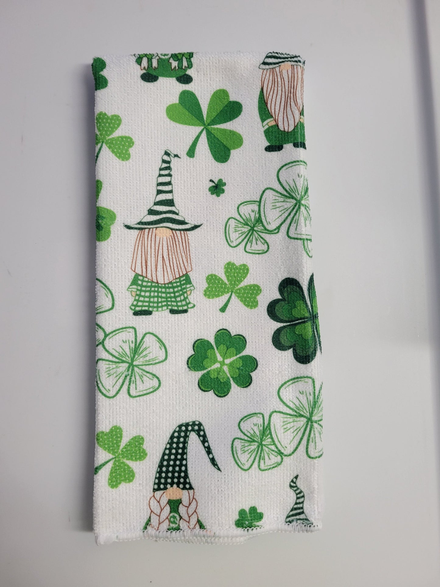 Putt Pantry St. Patricks Day Gnome Decor Bundle, 2 Decorative St Patty Kitchen Towels, Set of Gnome Salt and Pepper Shakers, 1 lb of Milk Chocolate Mint Truffles, packaged by Putt Pantry in a Wire Basket.