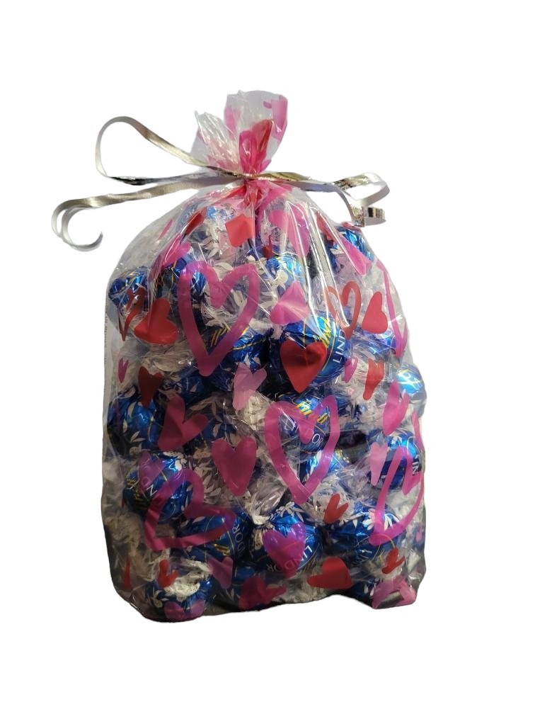 Valentines's Day Snoopy Bundle Basket. 1 plush Heart Snoopy, 1 9 oz bag Hershey's Chocolate Dipped Strawberry Kisses, 1 8.8 oz bag of Hershey's Pink Cookies N' Creme Hearts, with Heart Shaped Basket