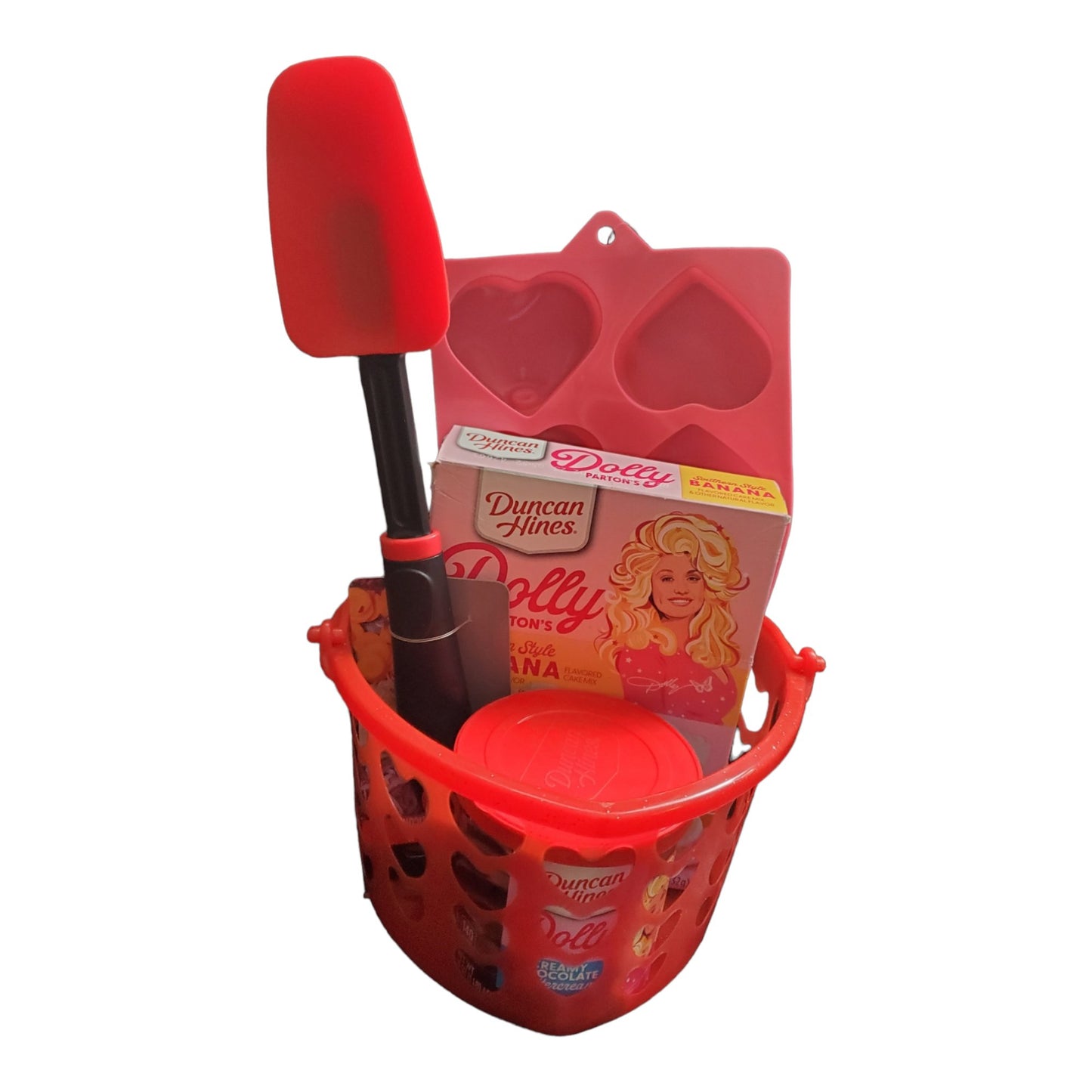 Dolly Parton Cake Gift Bundle for Valentine's Day, 1 15.25 oz box of cake mix, 1 16 oz container of frosting, 1 spatula, and a heart shaped basket