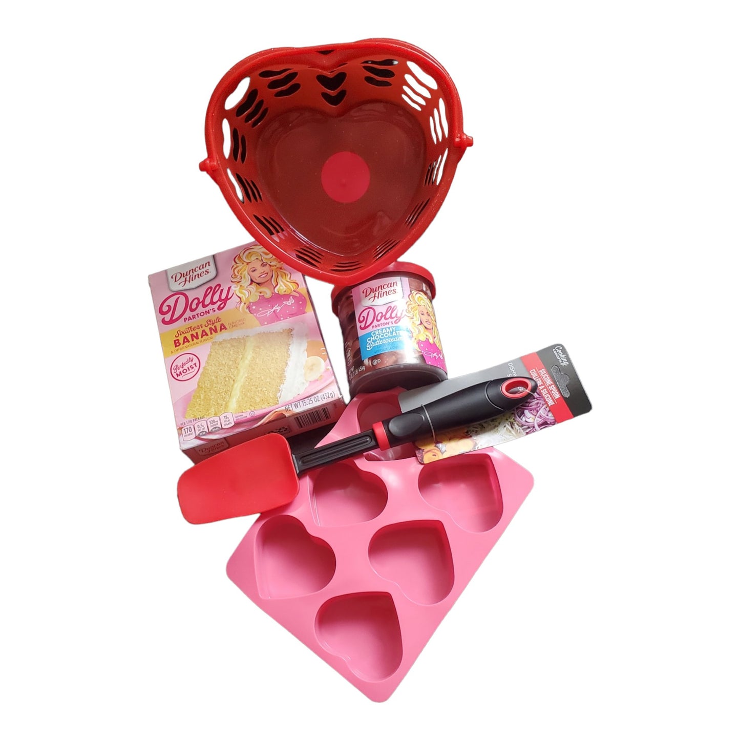 Dolly Parton Cake Gift Bundle for Valentine's Day, 1 15.25 oz box of cake mix, 1 16 oz container of frosting, 1 spatula, and a heart shaped basket