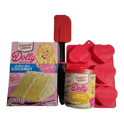 Dolly Parton Cake Gift Bundle for Valentine's Day, 1 15.25 oz box of cake mix, 1 16 oz container of frosting, 1 spatula, and a heart shaped basket
