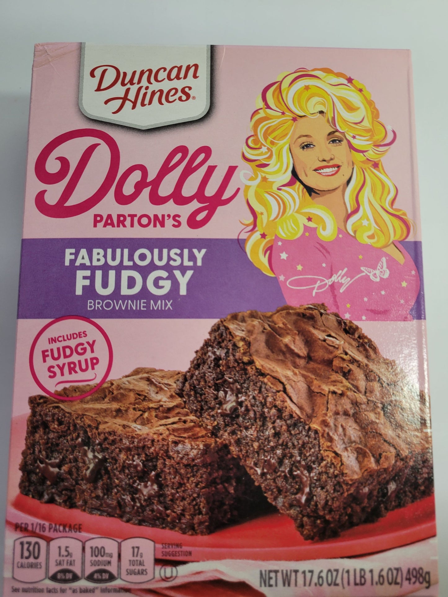 Duncan Hines Dolly Parton Brownie Bundle, 1 box 17.6 oz of Dolly Partons Fabulously Fudgy Brownie Mix, 1 box 16.7 oz of Dolly Parton Carmel Turtle Brownie Mix, 2 containers 16 oz of Dolly Partons Creamy Buttercream Frosting and 1 spatula