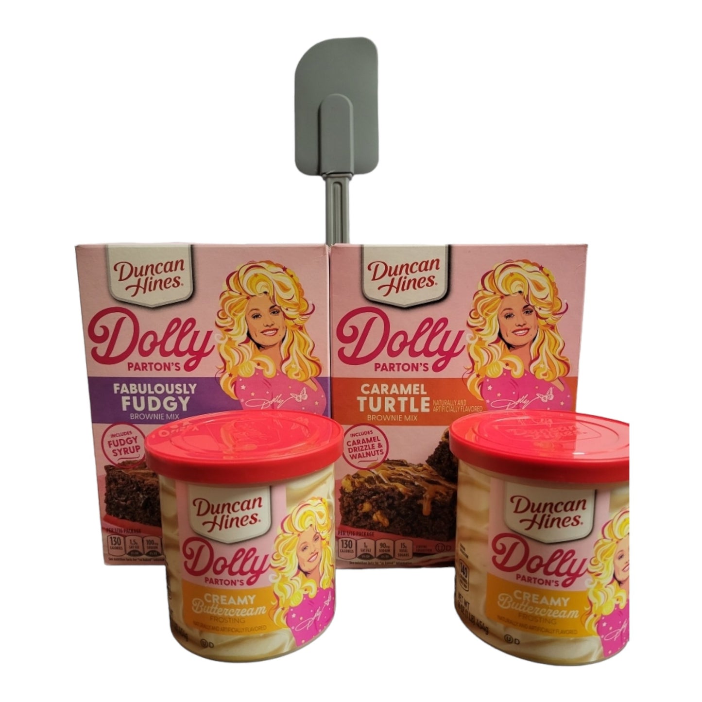 Duncan Hines Dolly Parton Brownie Bundle, 1 box 17.6 oz of Dolly Partons Fabulously Fudgy Brownie Mix, 1 box 16.7 oz of Dolly Parton Carmel Turtle Brownie Mix, 2 containers 16 oz of Dolly Partons Creamy Buttercream Frosting and 1 spatula