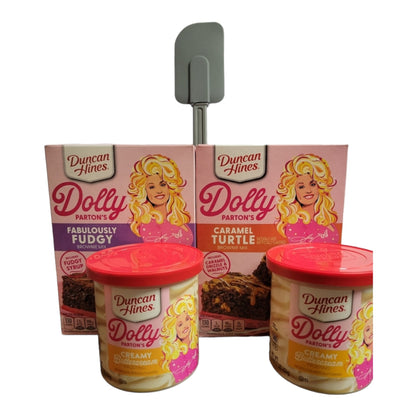 Duncan Hines Dolly Parton Brownie Bundle, 1 box 17.6 oz of Dolly Partons Fabulously Fudgy Brownie Mix, 1 box 16.7 oz of Dolly Parton Carmel Turtle Brownie Mix, 2 containers 16 oz of Dolly Partons Creamy Buttercream Frosting and 1 spatula